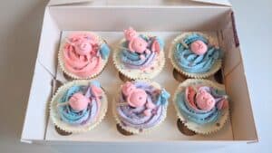 Pastel pink blue and lilac swirl Piggy Themed Cupcakes