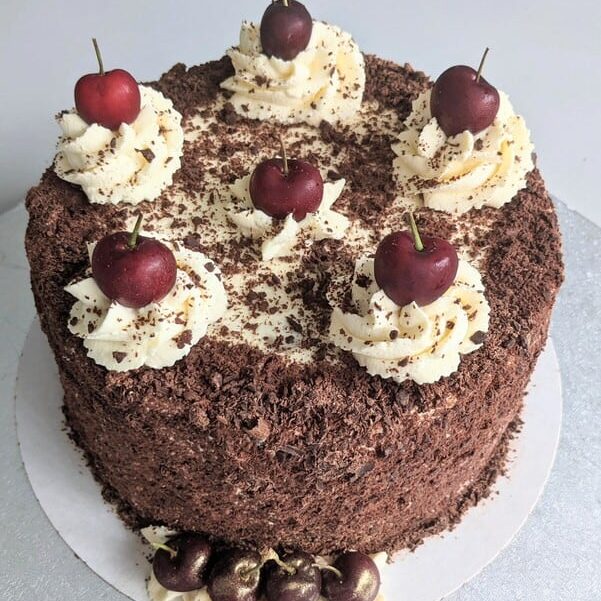 Black Forest Gateau 4 chocolate sponge layered gateau with fresh cream cherry compote chocolate shavings and fresh cherries
