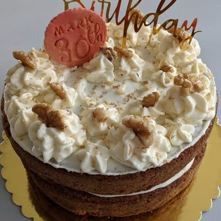 Traditional nutty Carrot Cake with cream cheese frosting and whole walnuts